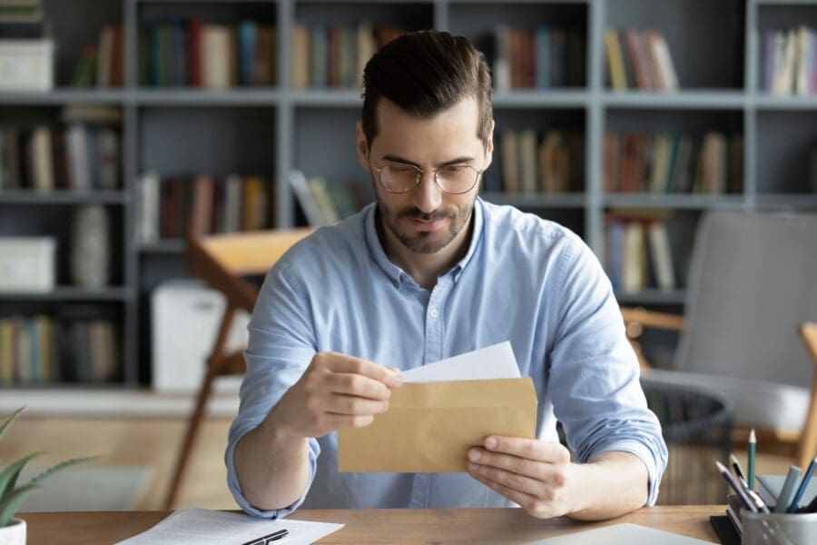 A business owner looks over the contents of a bank letter for accuracy.