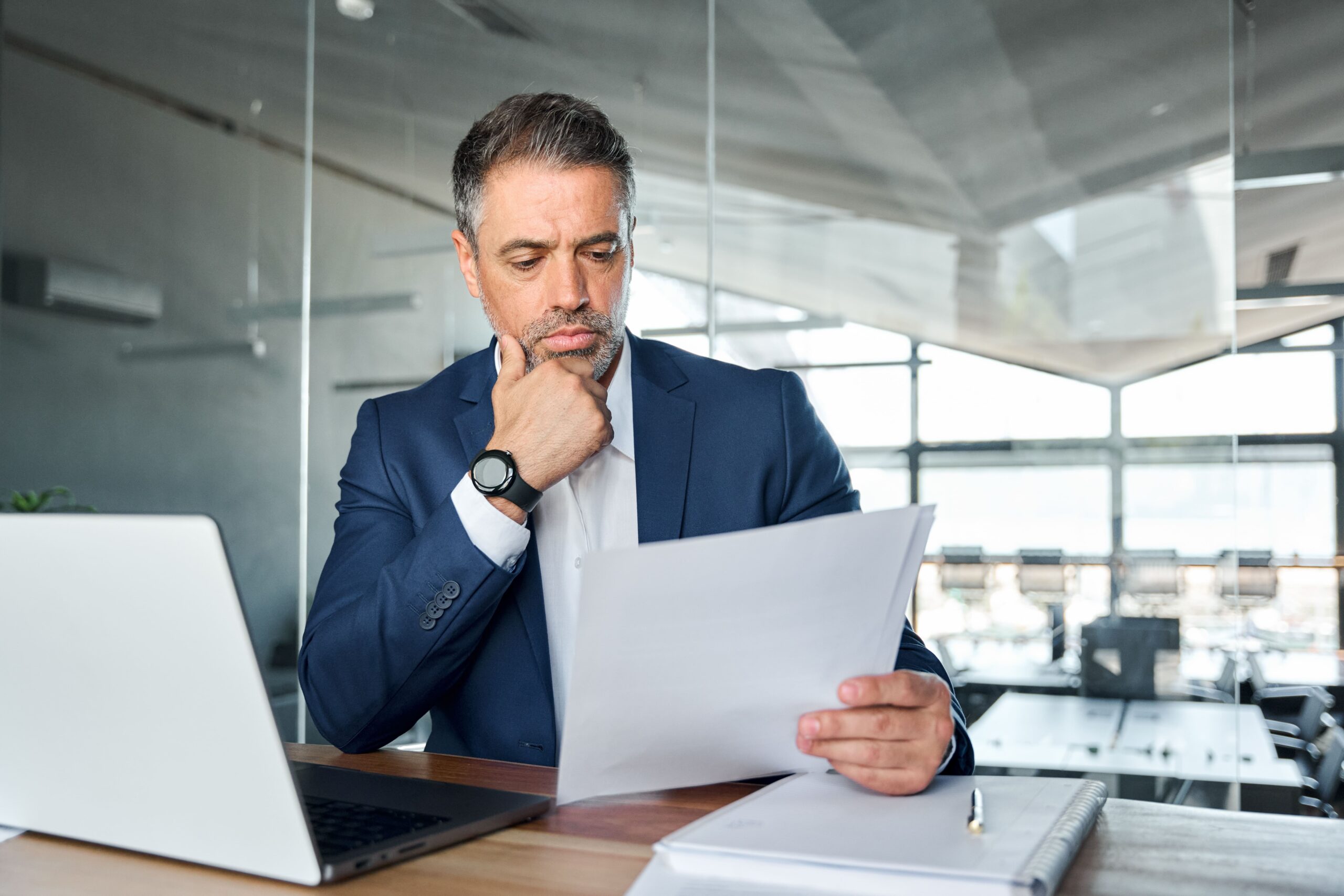 A business owner reviews a bank letter to ensure the information is accurate A business owner reviews a bank letter to ensure the information is accurate
