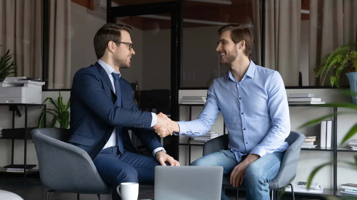 A banker shakes hands with a private client.