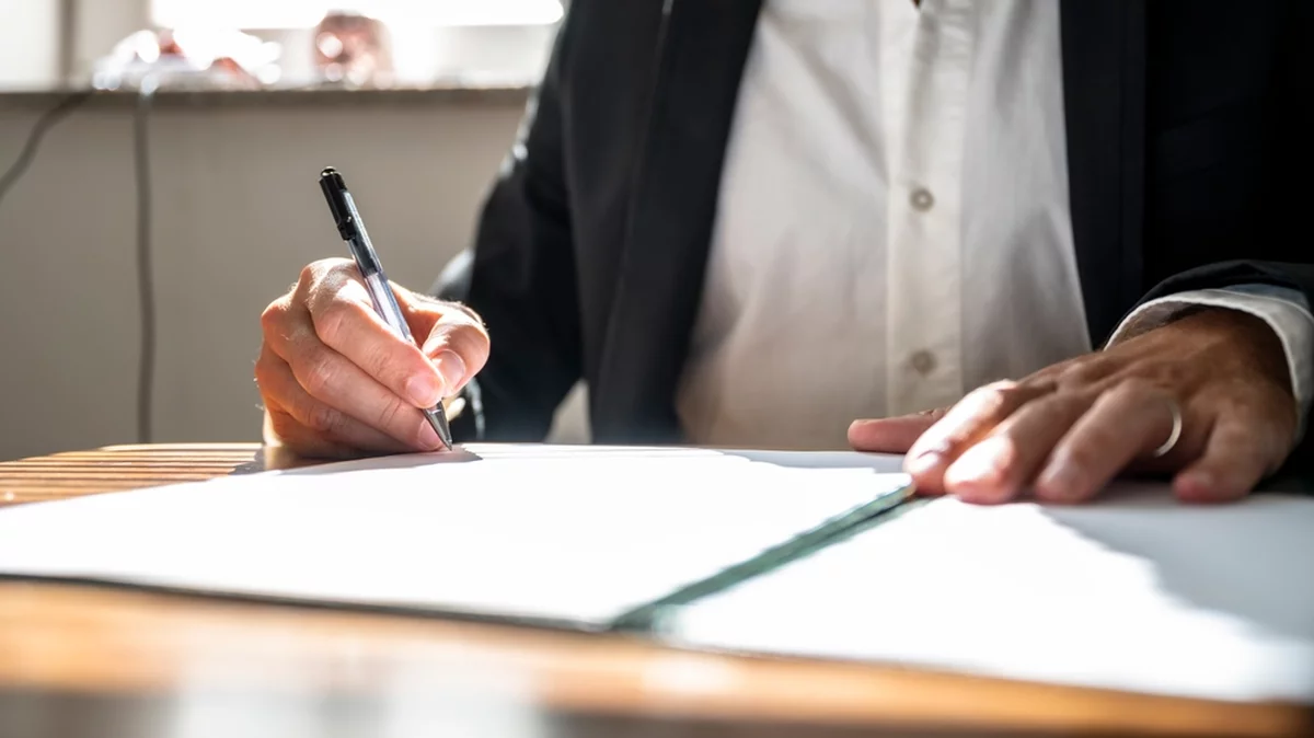 A paymaster manages high-value transactions using a ledger book.